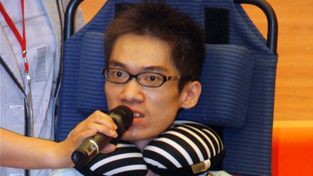 David Tseng, who suffers from a genetic muscular disease, speaking at his "memorial service" in an auditorium of a medical school in the southern Taiwan city of Kaohsiung.