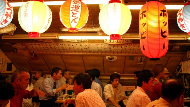 Patrons enjoying Friday night at Ton Ton Yakitori bar, Ginza.