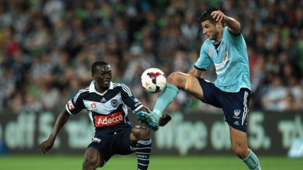 Going hard: Sydney's Terry Antonis clashes with Victory's Adama Traore on Saturday night.  