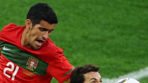Brazil's striker Nilmar fights for the ball with Portugal's defender Ricardo Costa.