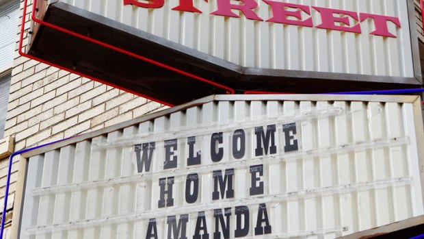 A sign welcoming home Amanda Knox is seen at the Easy Street record store in the neighborhood where she grew up.