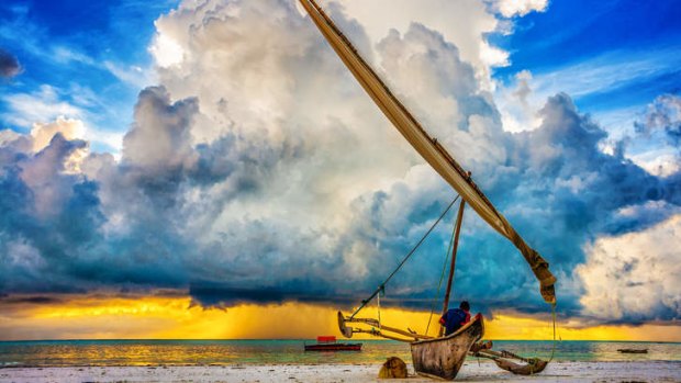 A fisherman watches a storm approach Zanzibar.