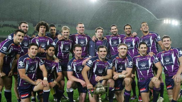 Winning style: The Storm show off the Michael Moore Trophy after beating the Warriors.