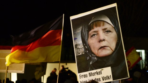 German Chancellor Angela Merkel, pictured wearing an Islamic headscarf, has been criticised for her migrant-friendly stance.