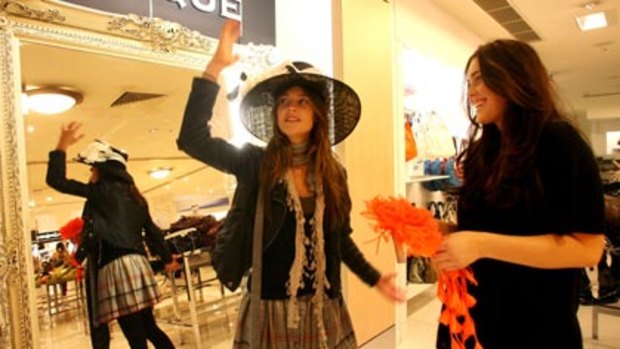 A safe fashion bet...shoppers Alexandra and Penny study their form in new season hats at the Myer city store yesterday.