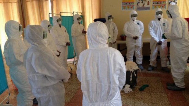 Dr Dan Lucey, of the Georgetown University Medical Centre (right), shows a session he supervised to train local health workers how to properly put on and take off equipment to protect against the Ebola virus.