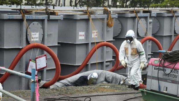 Ongoing disaster: workers at the crippled Fukushima Daiichi nuclear power plant, where contaminated water is now washing into the sea.