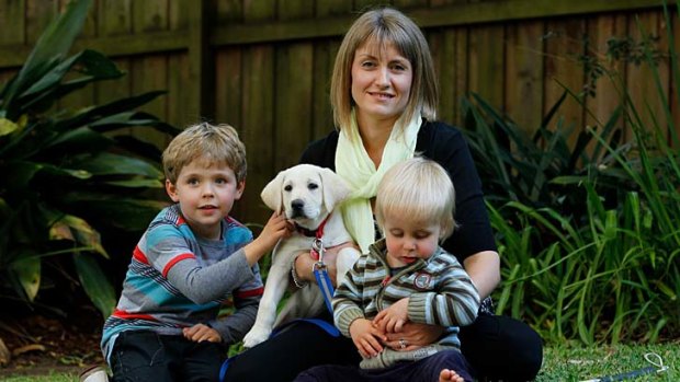 One step at a time: Janine Holt with her five-year-old son, Joshua, and 20-month-old son, Lachlan, who is vision impaired and in training to use a guide dog in order to get around.