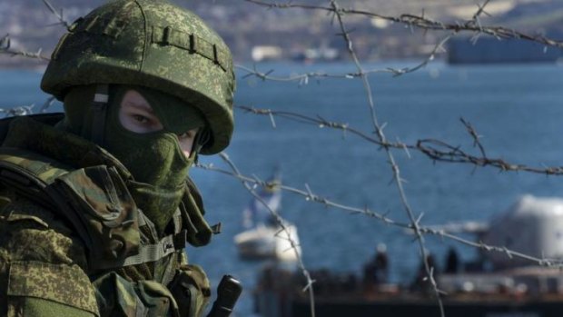 Still high troop numbers ... Russian soldiers guard a naval base in Sevastopol, Ukraine.