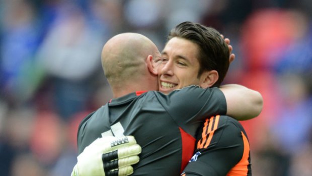 Liverpool goalkeeper Brad Jones (right) embraces suspended teammate Pepe Reina after the Reds beat Everton to reach the FA Cup final.