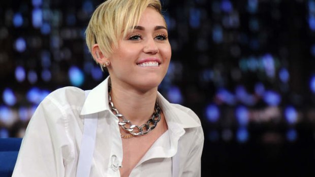 Promotion time: Miley Cyrus guests on  "Late Night With Jimmy Fallon" in New York on Tuesday.