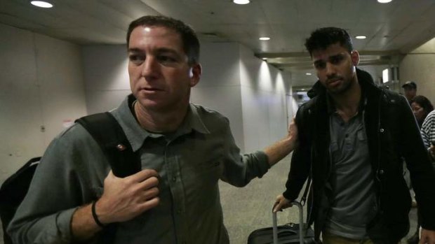 US journalist Glenn Greenwald (left) walks with his partner David Miranda in Rio de Janeiro's International Airport August 19, 2013.
