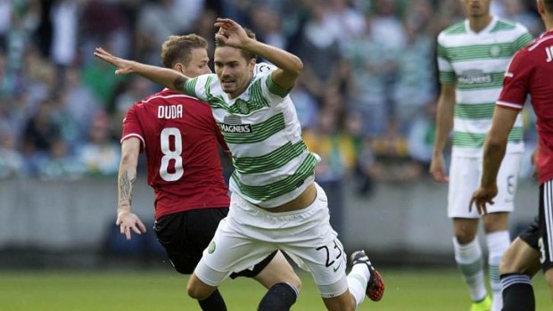 Celtic's Mikael Lustig takes a tumble against Legia Warsaw on Wednesday.
