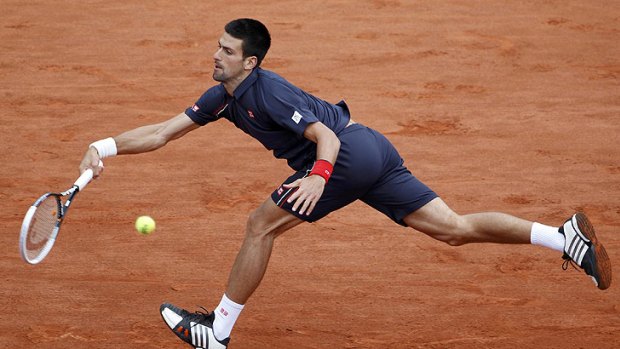 Novak Djokovic at full stretch in the final of the French Open, which was stopped due to rain.