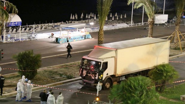 Authorities investigate a truck after it ploughed through Bastille Day revellers in the French resort city of Nice last July.