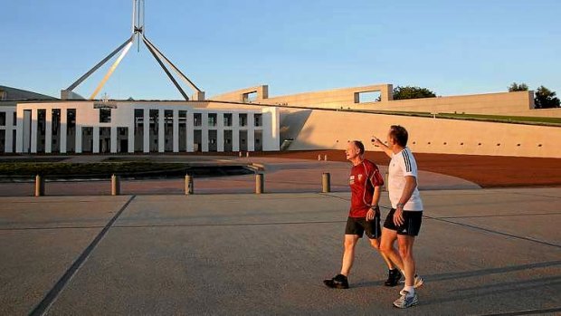 Queensland Premier Campbell Newman and Prime Minister Tony Abbott return to Parliament House after an early morning run around Lake Burley Griffin.