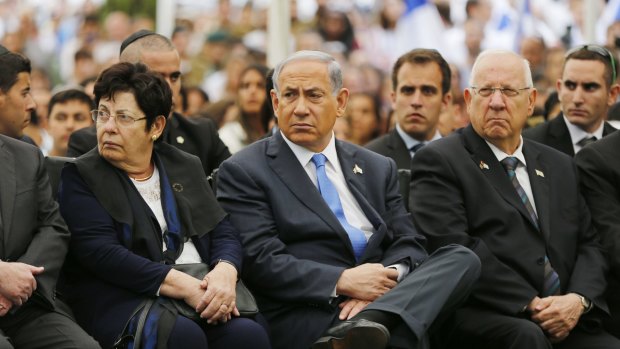 Benjamin Netanyahu, centre, sits next to President Reuven Rivlin, right, at a Memorial Day ceremony in Jerusalem last month.