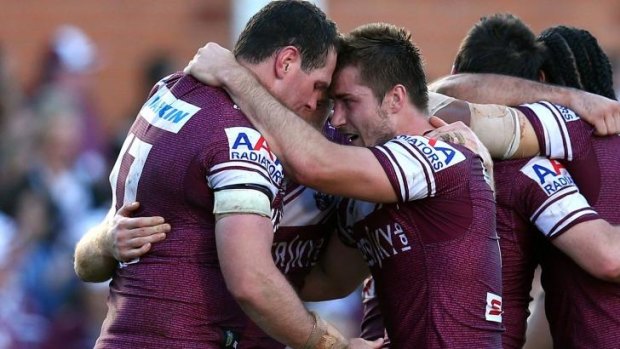 Timely win: Manly players celebrate after their fightback.