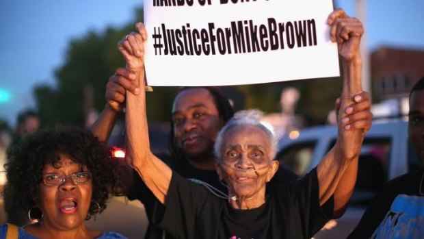 Eighty-eight-year-old Creola McCalister joins other demonstrators protesting the killing of teenager Michael Brown outside Greater St. Marks Family Church in Ferguson on Monday.