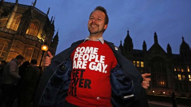 A campaigner demonstrates outside the British parliament, which has voted to legalise same-sex marriage.