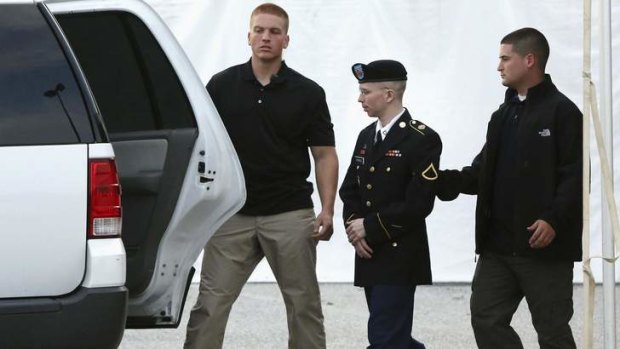 Blowing the whistle: Private Bradley Manning is escorted out of his court martial at Fort Meade, Maryland.