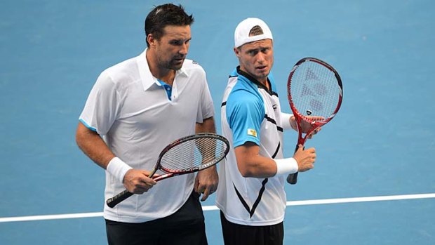 Double trouble: Pat Rafter and Lleyton Hewitt during their first-round match on Wednesday.