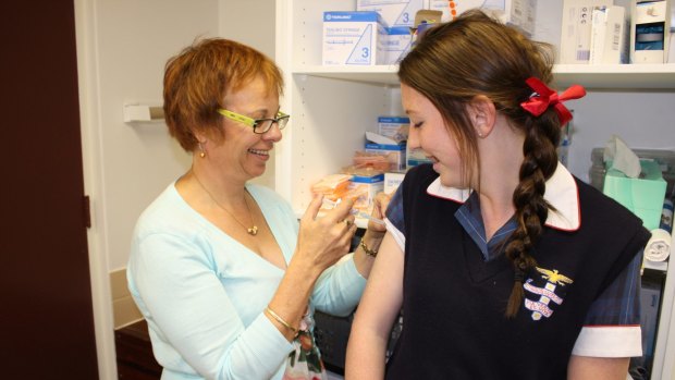 A girl receives  the HPV vaccine.