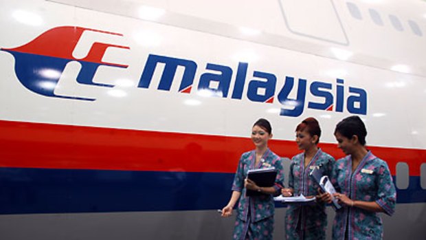 The flight stuff ... Malaysia Airlines cabin crew outside a full-scale model plane cabin.