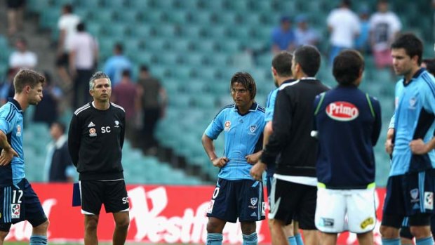 The hip parade &#8230; a dejected Nicky Carle with Sydney FC staff and teammates after the side's 1-0 loss to A-League leaders, Central Coast,  at the Sydney Football Stadium yesterday. The Mariners did it far easier than the scoreline suggests.