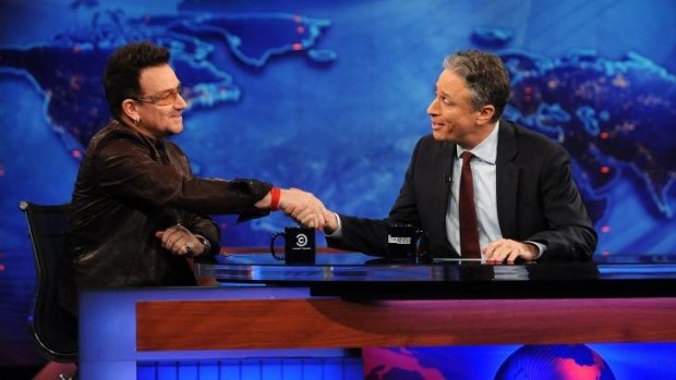 In 2011, U2 frontman Bono, left, shakes hands with host Jon Stewart.