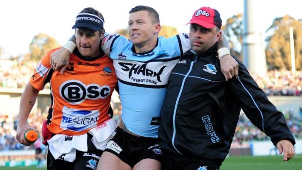 Sharks player Todd Carney leaves the field with an ankle injury.