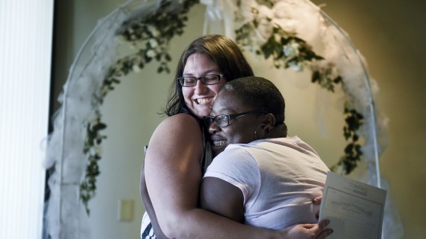Vindicated: Jana Hayes, left, and Angie Hayes embrace under an altar at the Citizens Service Centre in Colorado Springs, Colorado.
