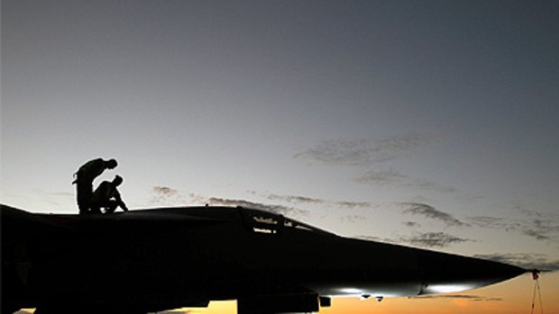 Ground crew prepare  a RAAF F-111 taking part in the aircrafts' last major international excersise Operation Pitch Black  in the skies above the Northern Territory.