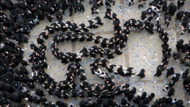 Ultra-Orthodox Jews gather in Jerusalem to demonstrate against plans to make them undergo military service. 