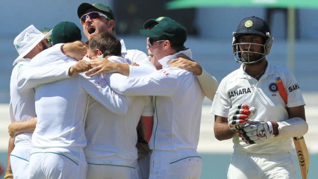Home-ground advantage: India's Cheteshwar Pujara departs as South Africa celebrate on the final day of their second Test victory over India at Kingsmead in Durban. The Proteas won the series 1-0.