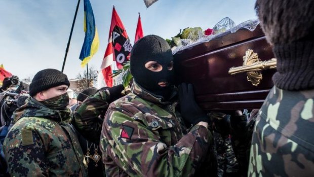 Men carry a casket containing the body of a protester who was killed in clashes with police in Kiev.