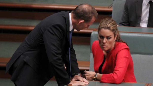 Mutual loyalty: Prime Minister Tony Abbott, then opposition leader, speaks to his chief of staff Peta Credlin in Parliament.