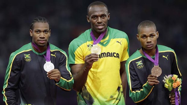 Trifecta ... ...  Usain Bolt, centre, is flanked by silver medallist Yohan Blake, left, and bronze medal winner Warren Weir.