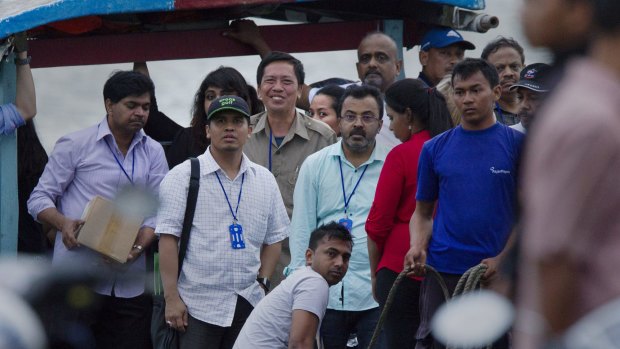 Febyanti Herewila (centre), wife of Andrew Chan, stands behind relatives of the Bali nine.