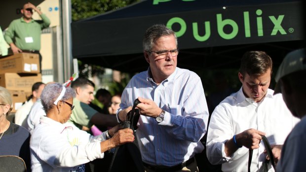 Former Florida governor Jeb Bush hands out food to the needy in Miami earlier this month.