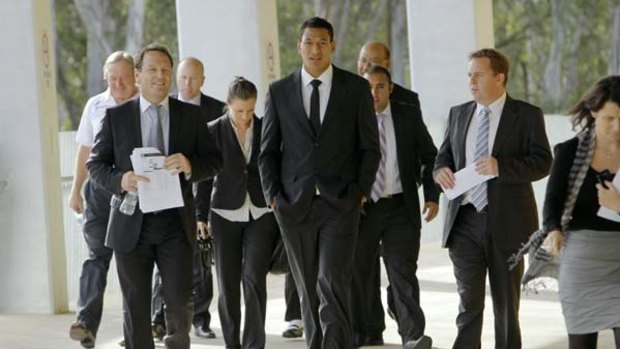 Walk this way  ... Greater Western Sydney officials escort Israel Folau to the news conference where he announced his historic move from rugby league to Australian football.