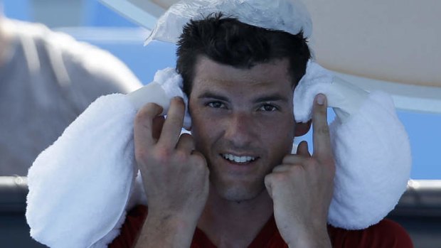 Keeping cool: Frank Dancevic applies an ice pack to his head.