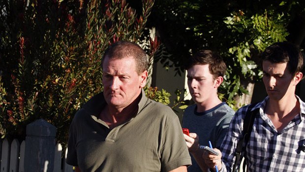 Walk of shame ... Ricky Nixon leaves St Kilda police station after his domestic spectacle.