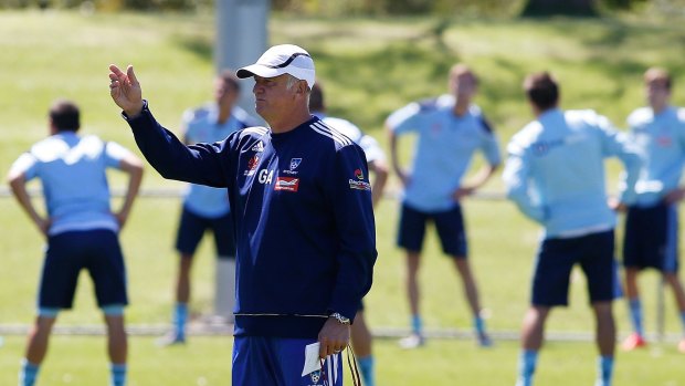 Graham Arnold directs a training session at Macquarie Field on Thursday.