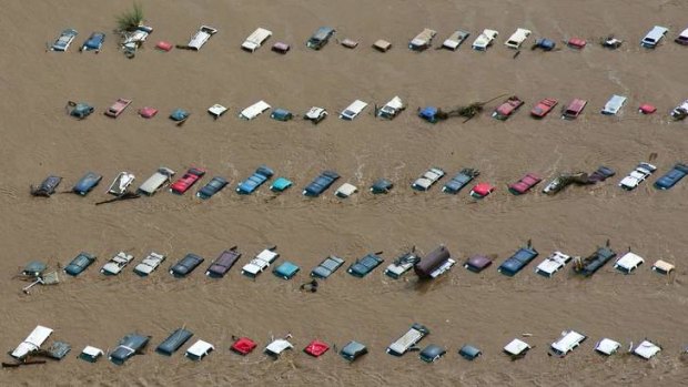 An aerial view of vehicles submerged in flood waters along the South Platte River near Greenley, Colorado.