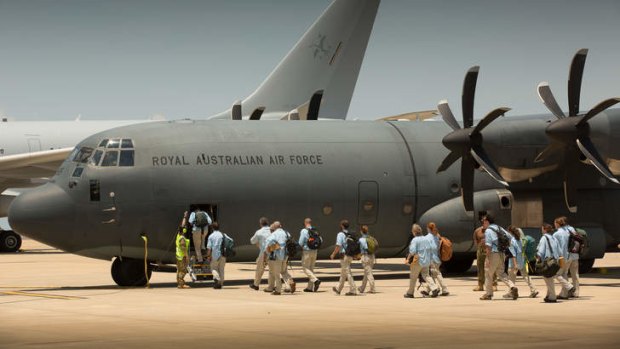 A civilian Australian Medical Assistance Team boards a C-130 Hercules enroute to the Philippines to conduct emergency relief operations following typhoon Haiyan.