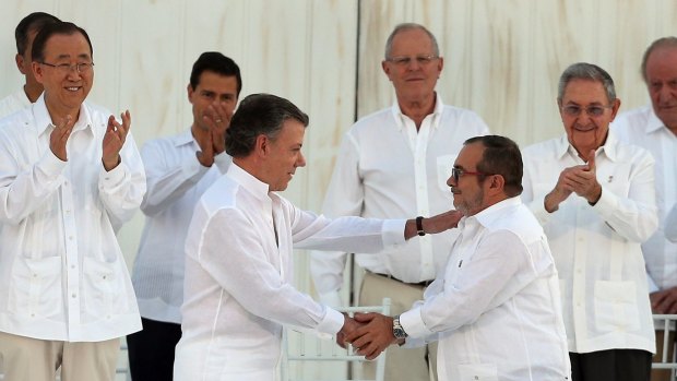 Historic agreement: Colombian President Juan Manuel Santos, front left, and the top FARC commander Rodrigo Londono, known by the alias Timochenko, shake hands after signing the original peace deal. 
