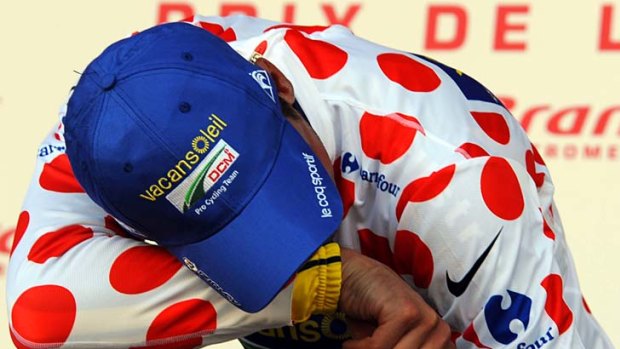 New polka dot jersey holder for best climber, Johnny Hoogerland, cries on the podium after being hit by a car during stage nine.