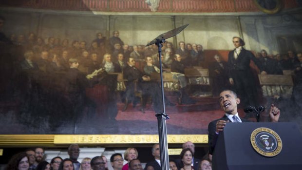 Brave face: President Barack Obama defends his healthcare law at Faneuil Hall in Boston.