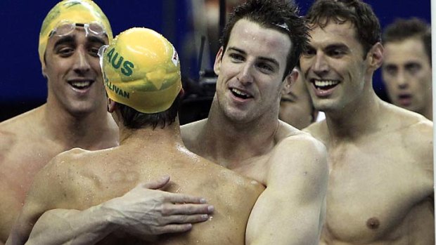 Australian team embrace Eamon Sullivan after winning the gold medal in the men's 4x100m freestyle.